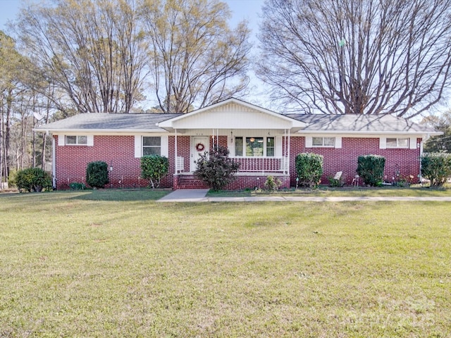 single story home with brick siding and a front yard