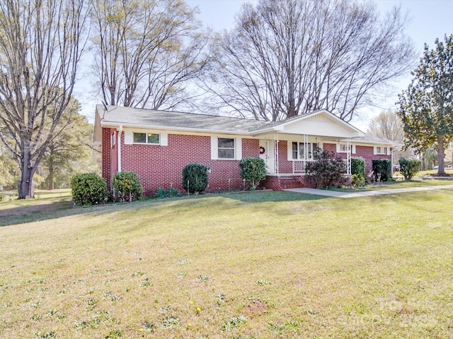 ranch-style home with a front yard and brick siding