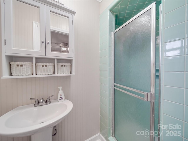 full bathroom featuring a sink and a shower stall
