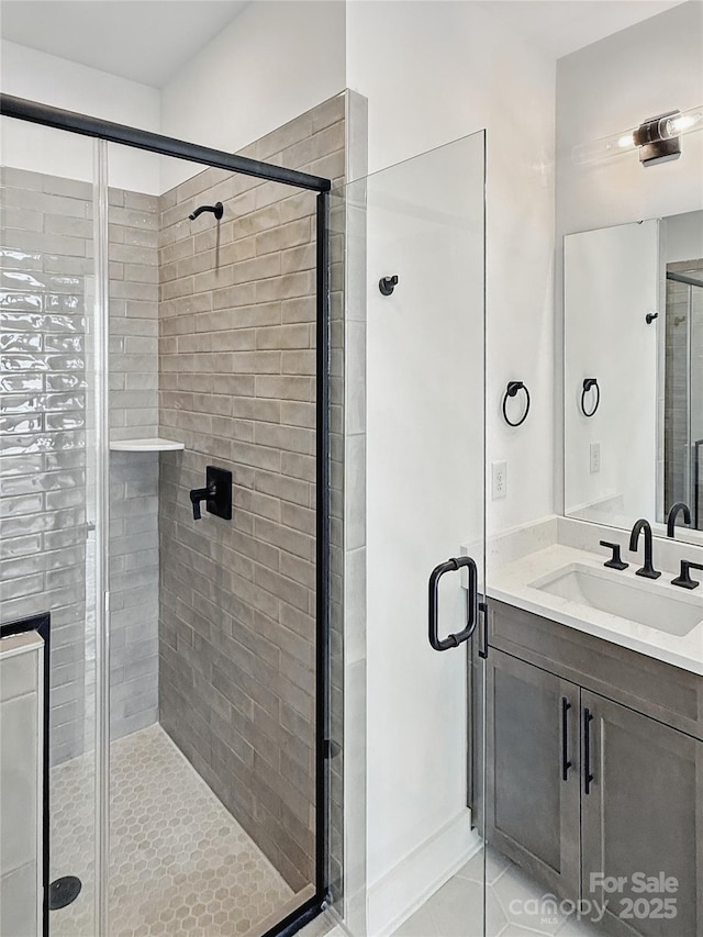 full bathroom featuring tile patterned floors, a shower stall, and vanity