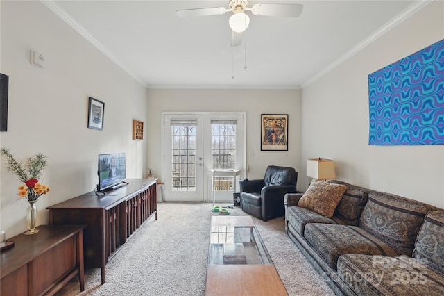 carpeted living room with french doors, ornamental molding, and a ceiling fan