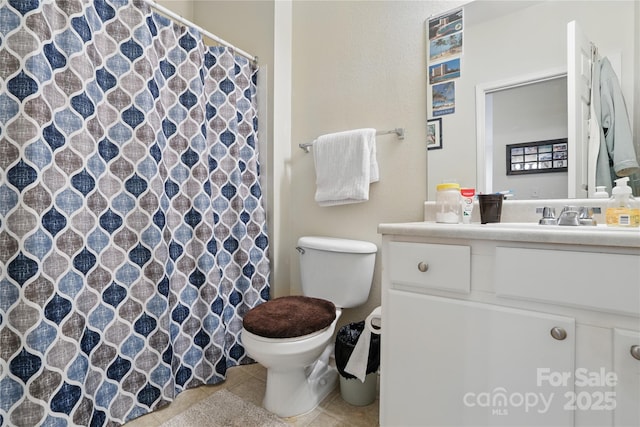 bathroom with a shower with shower curtain, toilet, tile patterned flooring, and vanity