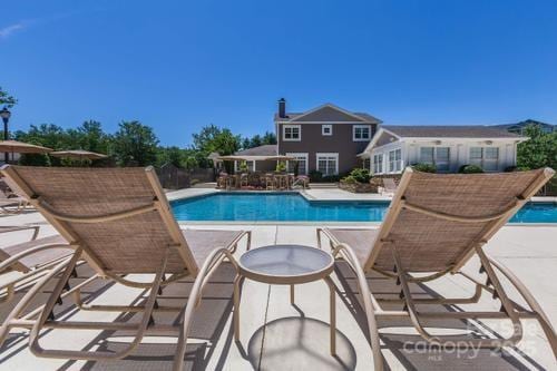 outdoor pool featuring a patio