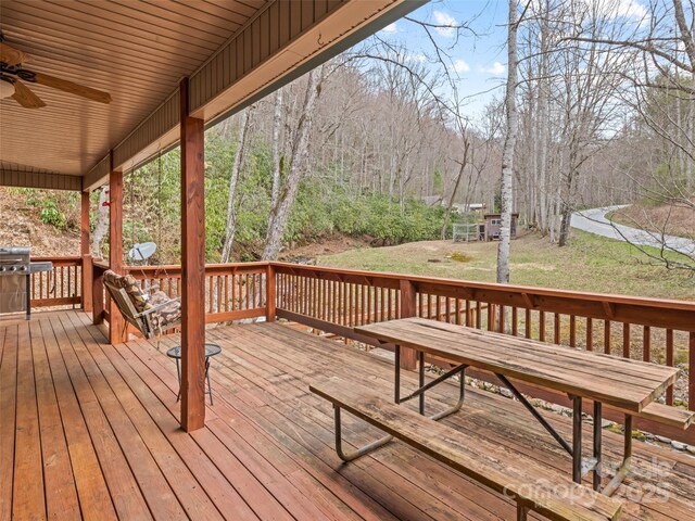 3975 Mountain Creek Rd, Robbinsville, NC 28771 - deck featuring a grill, a ceiling fan, and a yard