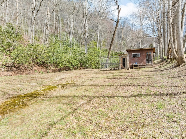 3975 Mountain Creek Rd, Robbinsville, NC 28771 - view of yard featuring an outbuilding, a forest view, and exterior structure