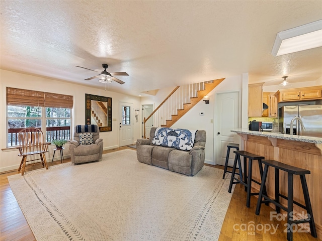 3975 Mountain Creek Rd, Robbinsville, NC 28771 - living area with a ceiling fan, stairway, light wood finished floors, and a textured ceiling