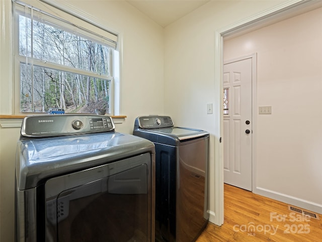 3975 Mountain Creek Rd, Robbinsville, NC 28771 - laundry room featuring independent washer and dryer, baseboards, light wood finished floors, visible vents, and laundry area