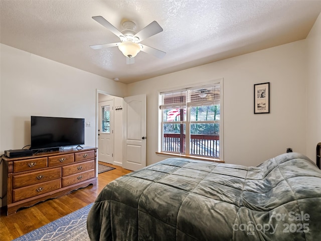 3975 Mountain Creek Rd, Robbinsville, NC 28771 - bedroom featuring a ceiling fan, light wood-style floors, and a textured ceiling