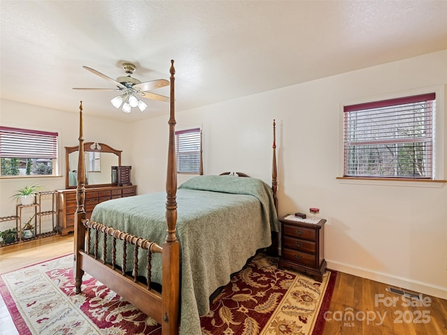 3975 Mountain Creek Rd, Robbinsville, NC 28771 - bedroom with visible vents, baseboards, ceiling fan, and wood finished floors
