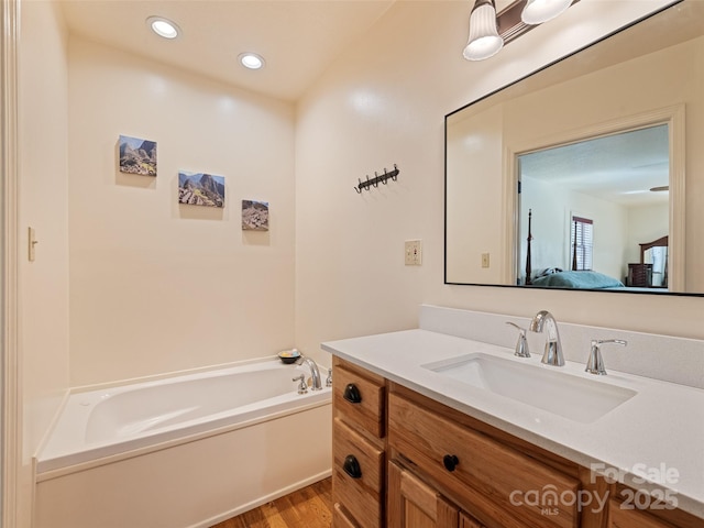 3975 Mountain Creek Rd, Robbinsville, NC 28771 - bathroom featuring vanity, a bath, recessed lighting, connected bathroom, and wood finished floors