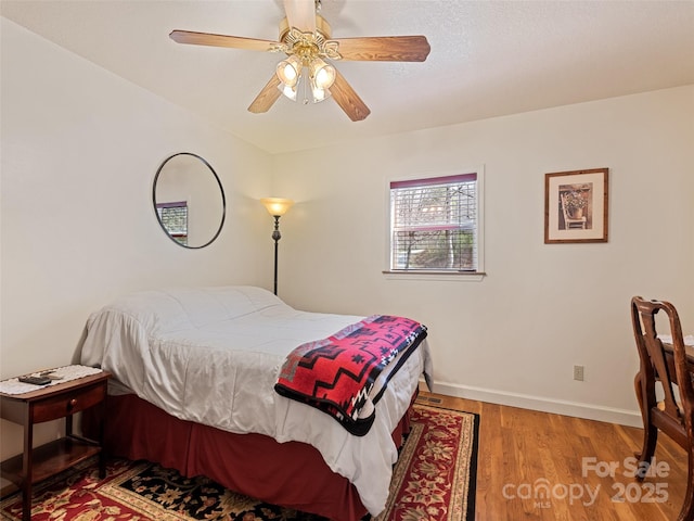 3975 Mountain Creek Rd, Robbinsville, NC 28771 - bedroom featuring baseboards, wood finished floors, and a ceiling fan