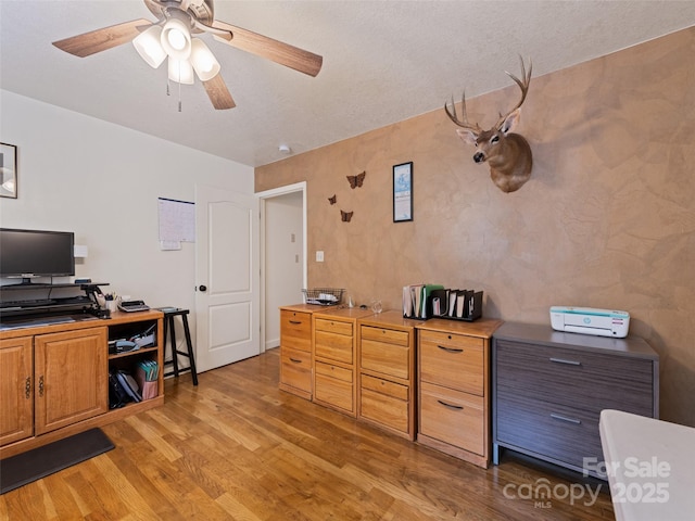3975 Mountain Creek Rd, Robbinsville, NC 28771 - home office featuring a ceiling fan, light wood-style flooring, and a textured ceiling