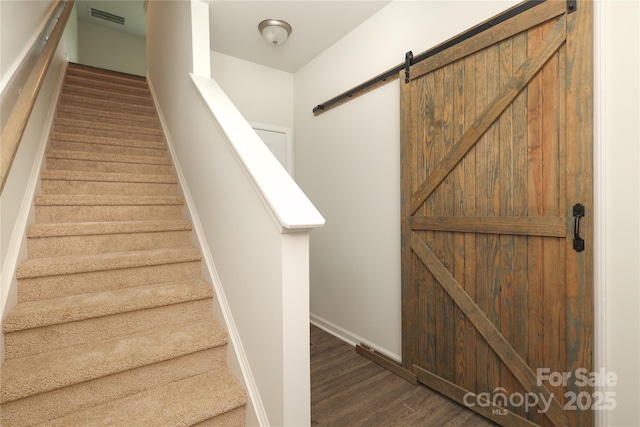 8232 Waxhaw Hwy, Waxhaw, NC 29173 - stairs with a barn door and wood finished floors