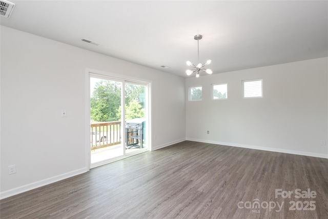 8232 Waxhaw Hwy, Waxhaw, NC 29173 - spare room featuring a chandelier, wood finished floors, and healthy amount of natural light