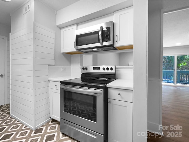 4936 Sardis Rd Unit B, Charlotte, NC 28270 - kitchen with light countertops, visible vents, white cabinets, and appliances with stainless steel finishes