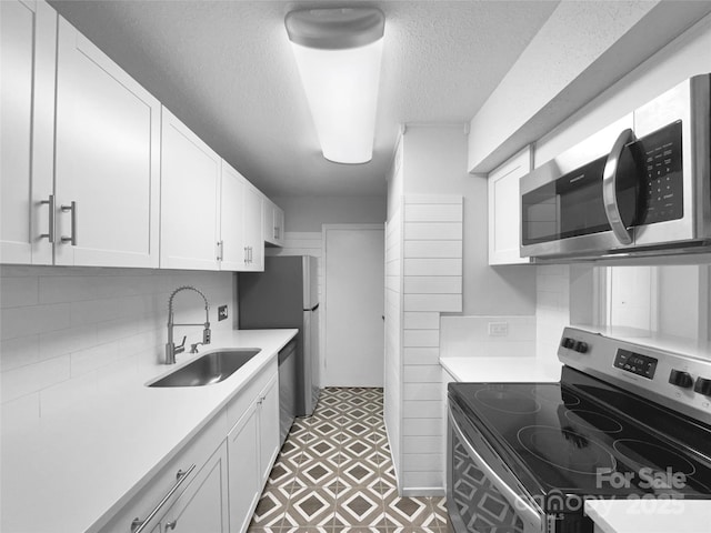 4936 Sardis Rd Unit B, Charlotte, NC 28270 - kitchen with white cabinets, light countertops, a sink, and appliances with stainless steel finishes