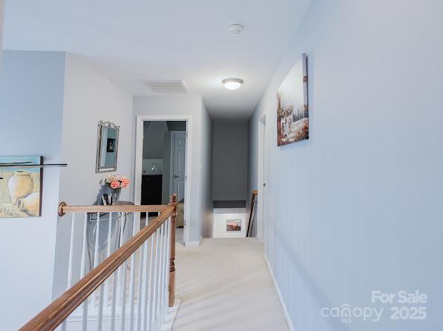 6000 Pine Cone Ln, Monroe, NC 28110 - hallway featuring baseboards and an upstairs landing