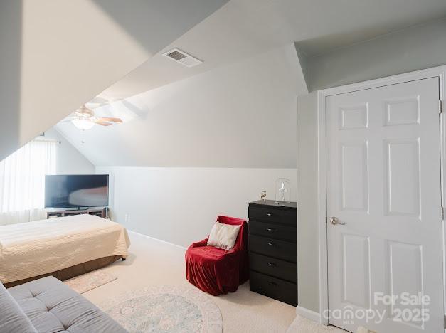 6000 Pine Cone Ln, Monroe, NC 28110 - carpeted bedroom with baseboards, vaulted ceiling, and visible vents