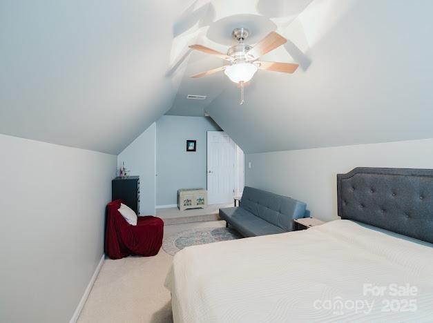 6000 Pine Cone Ln, Monroe, NC 28110 - bedroom featuring lofted ceiling, carpet, baseboards, ceiling fan, and visible vents