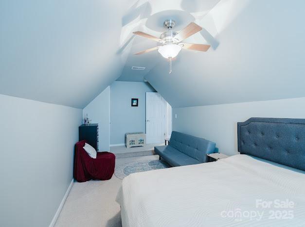 6000 Pine Cone Ln, Monroe, NC 28110 - carpeted bedroom with baseboards, vaulted ceiling, visible vents, and a ceiling fan