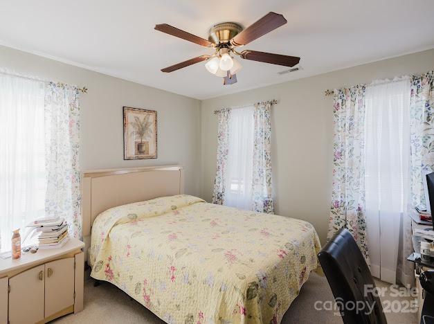6000 Pine Cone Ln, Monroe, NC 28110 - bedroom with ceiling fan, visible vents, and light carpet
