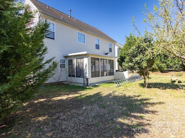 6000 Pine Cone Ln, Monroe, NC 28110 - rear view of property with a sunroom and a yard