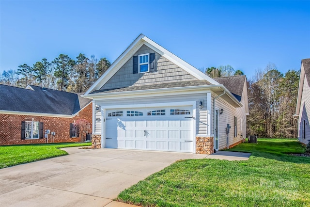 view of front of house featuring stone siding, central AC unit, an attached garage, concrete driveway, and a front yard