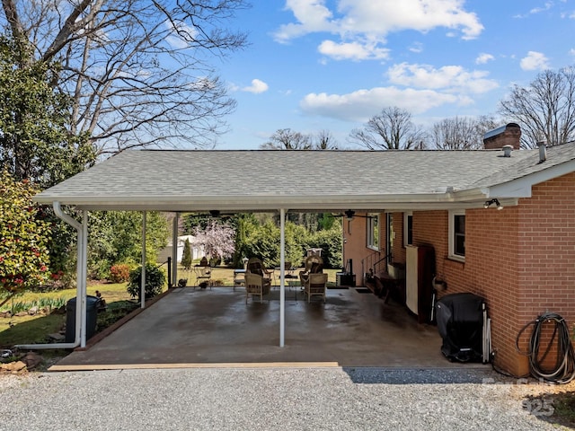 view of vehicle parking featuring entry steps and a carport