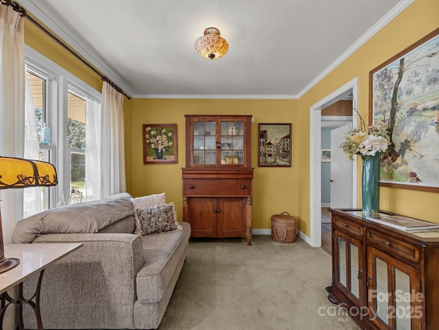 sitting room with baseboards, ornamental molding, and light colored carpet