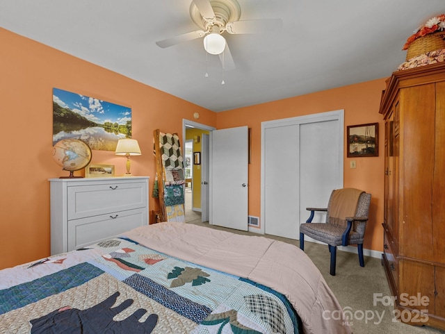 bedroom with baseboards, ceiling fan, a closet, and carpet floors