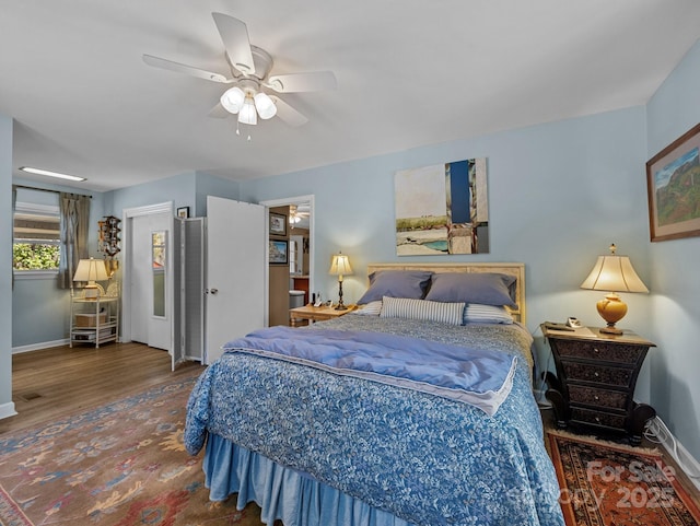 bedroom featuring baseboards, ceiling fan, and wood finished floors