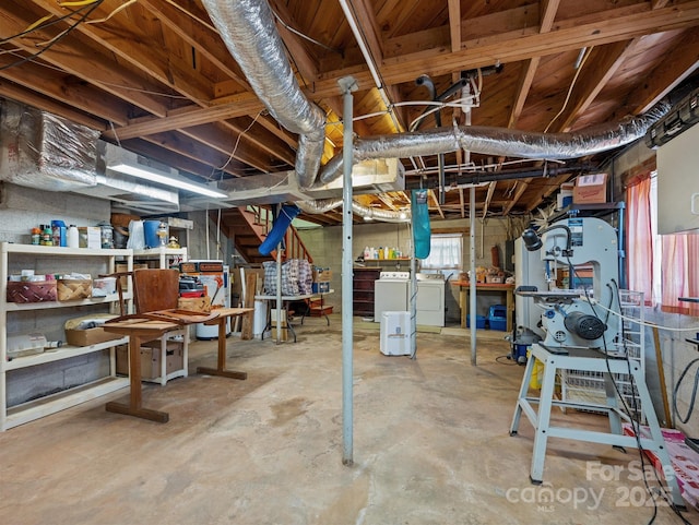 unfinished basement with stairs and washing machine and clothes dryer