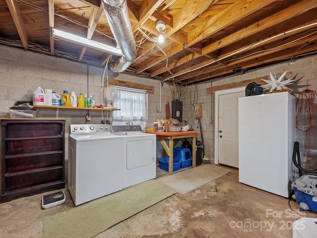 basement with separate washer and dryer, electric panel, and freestanding refrigerator