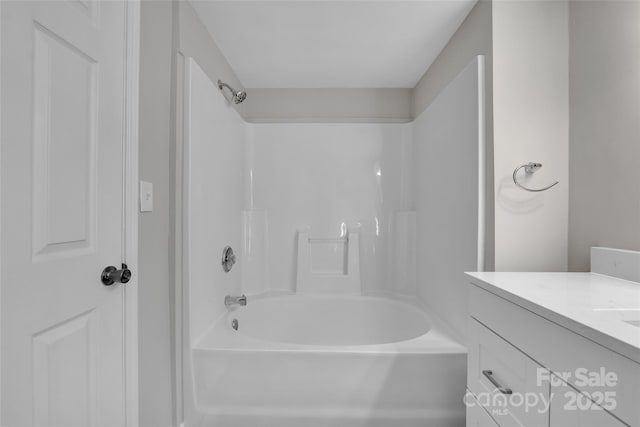 bathroom featuring vanity and shower / tub combination