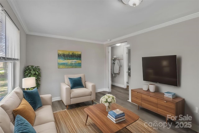 living area with baseboards, ornamental molding, and wood finished floors