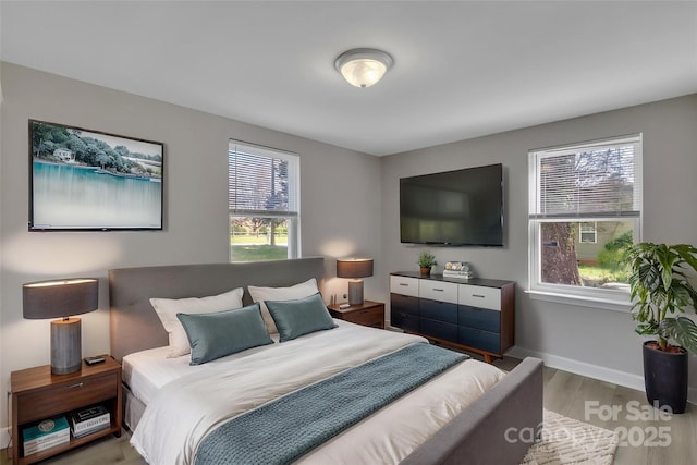 bedroom featuring baseboards and wood finished floors