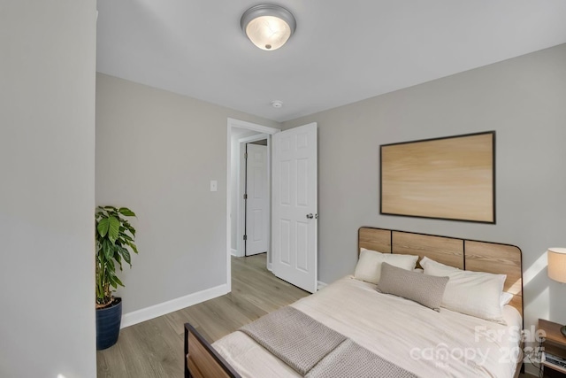 bedroom featuring baseboards and wood finished floors