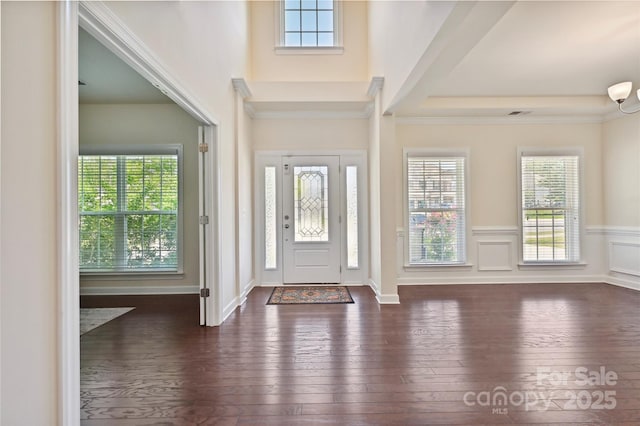9937 Travertine Trl, Davidson, NC 28036 - foyer entrance with dark wood-style flooring, a wainscoted wall, and crown molding