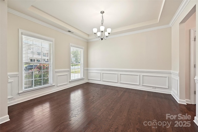 9937 Travertine Trl, Davidson, NC 28036 - unfurnished room with a chandelier, a raised ceiling, dark wood-style flooring, a wainscoted wall, and ornamental molding