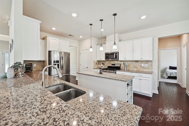 9937 Travertine Trl, Davidson, NC 28036 - kitchen with appliances with stainless steel finishes, a sink, white cabinetry, and recessed lighting