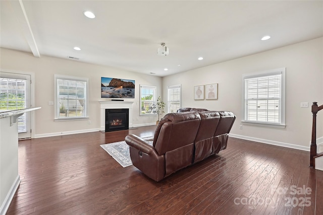 9937 Travertine Trl, Davidson, NC 28036 - living area featuring dark wood-type flooring, baseboards, a fireplace with flush hearth, and recessed lighting