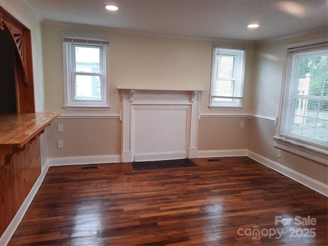 813 N Ave, Charlotte, NC 28208 - unfurnished living room featuring plenty of natural light, dark wood-type flooring, ornamental molding, and recessed lighting