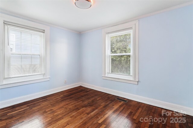 813 N Ave, Charlotte, NC 28208 - empty room with dark wood finished floors and ornamental molding