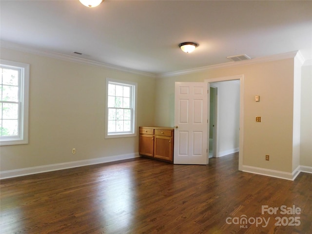 unfurnished room featuring ornamental molding, dark wood-style flooring, and baseboards