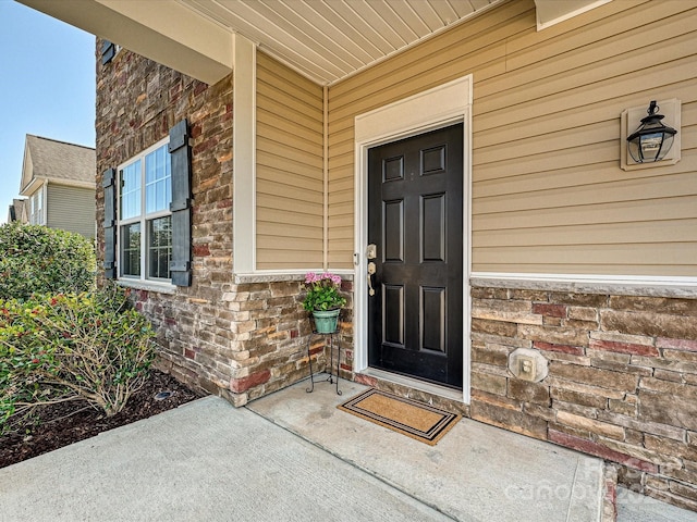 11621 Red Knoll Ln, Pineville, NC 28134 - view of exterior entry with brick siding, stone siding, and covered porch