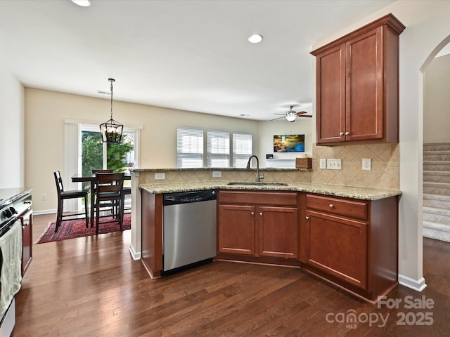 11621 Red Knoll Ln, Pineville, NC 28134 - kitchen featuring dishwasher, a sink, a peninsula, arched walkways, and tasteful backsplash