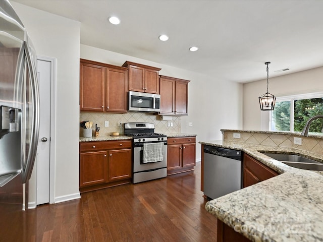 11621 Red Knoll Ln, Pineville, NC 28134 - kitchen with appliances with stainless steel finishes, a sink, dark wood-style floors, light stone countertops, and decorative backsplash