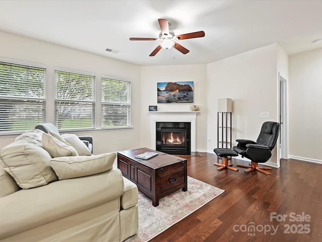 11621 Red Knoll Ln, Pineville, NC 28134 - living area featuring ceiling fan, wood finished floors, a fireplace with flush hearth, and baseboards