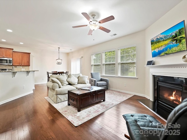 11621 Red Knoll Ln, Pineville, NC 28134 - living room featuring dark wood finished floors, ceiling fan, baseboards, recessed lighting, and a glass covered fireplace