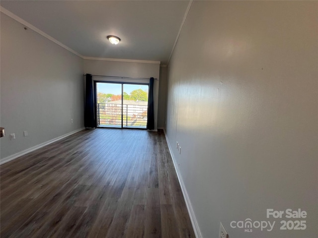 empty room featuring baseboards, dark wood-style floors, and ornamental molding